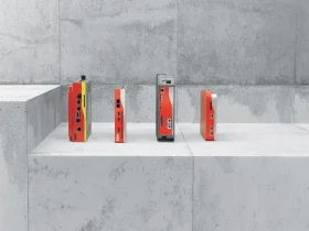 Four red MOVI-C® CONTROLLER on a concrete backdrop